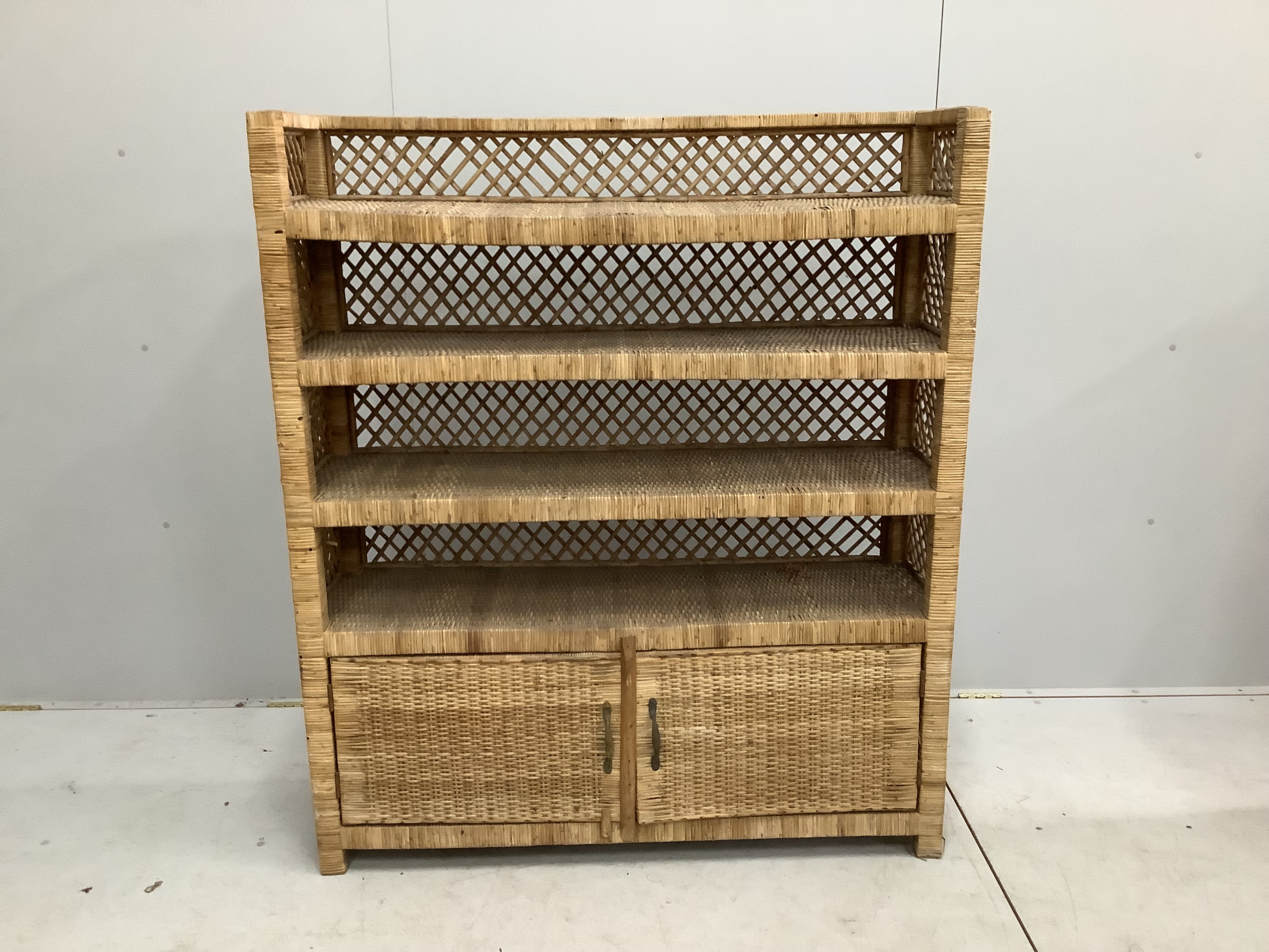 A wicker four tier shelf unit, width 121cm, depth 36cm, height 140cm, together with a wicker eight division tray